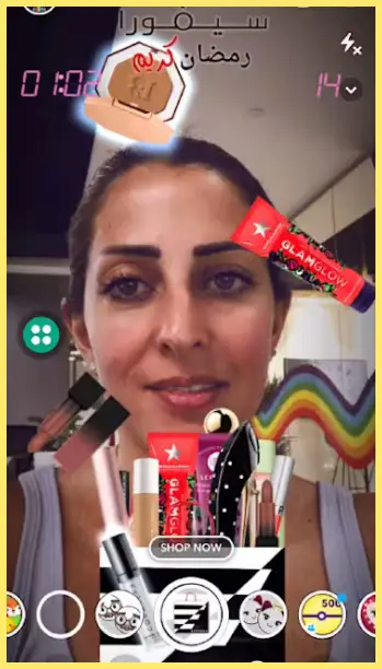 A woman using a snapchat filter that displays virtual makeup products and an interactive game interface on the screen.