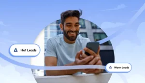 Smiling man holding a smartphone with visual tags labeled Hot Leads and Warm Leads on a light blue background.