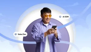 Smiling man looking at his phone with floating labels for Sales Development and AI SDR against a light blue background.